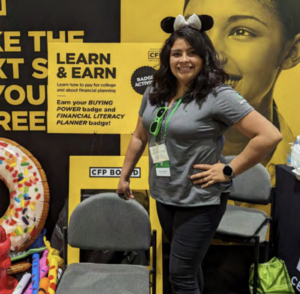 Photo of Carrisa Flores with mouse ears on at a community event